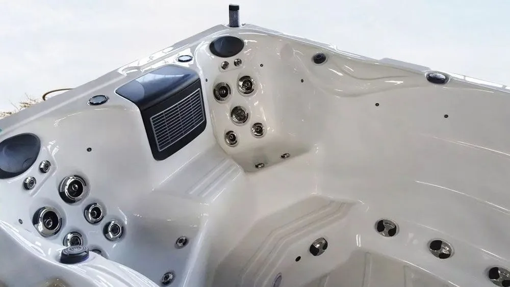 White hot tub with multiple jets and control panel.