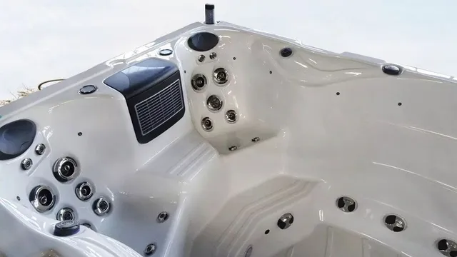 White hot tub with multiple jets and control panel.